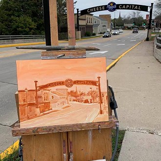 Dan Rizzi painting the Plymouth Cheese Capital Arch in 2021